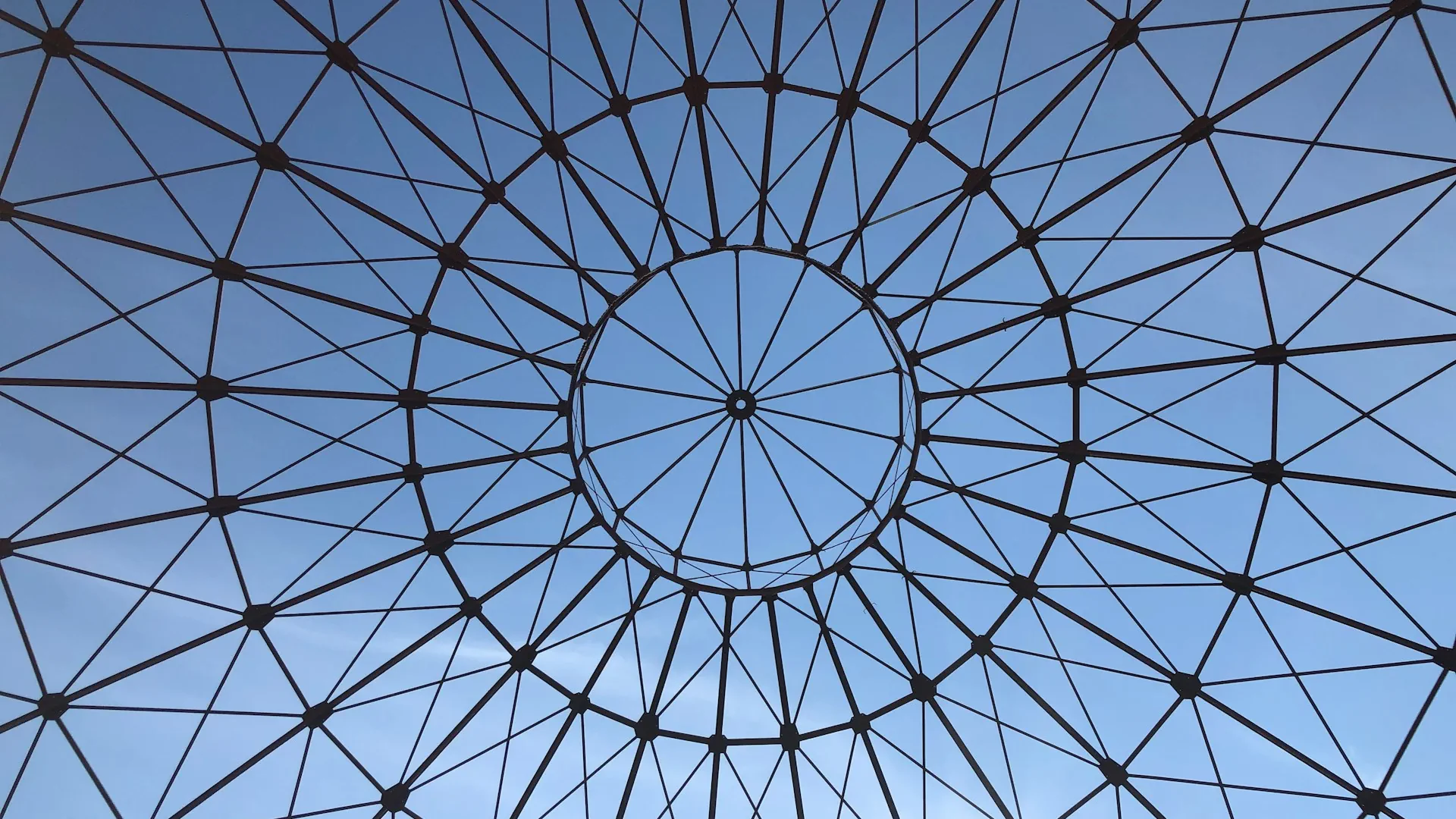 Black metal frame against a blue sky backdrop
