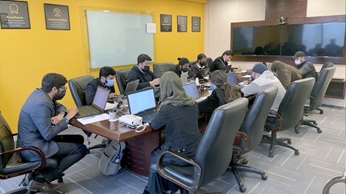 A meeting is going on in a meeting room.